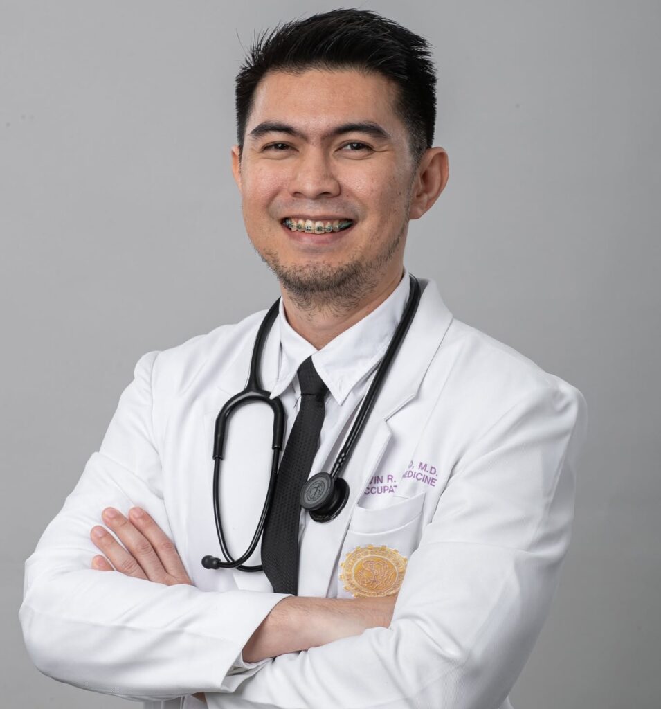 Doc A, family physician at Doc A Wellness, smiling in a white coat with stethoscope